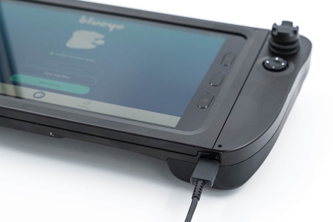 You charge the tablet through the USB-C port on the rugged controller.